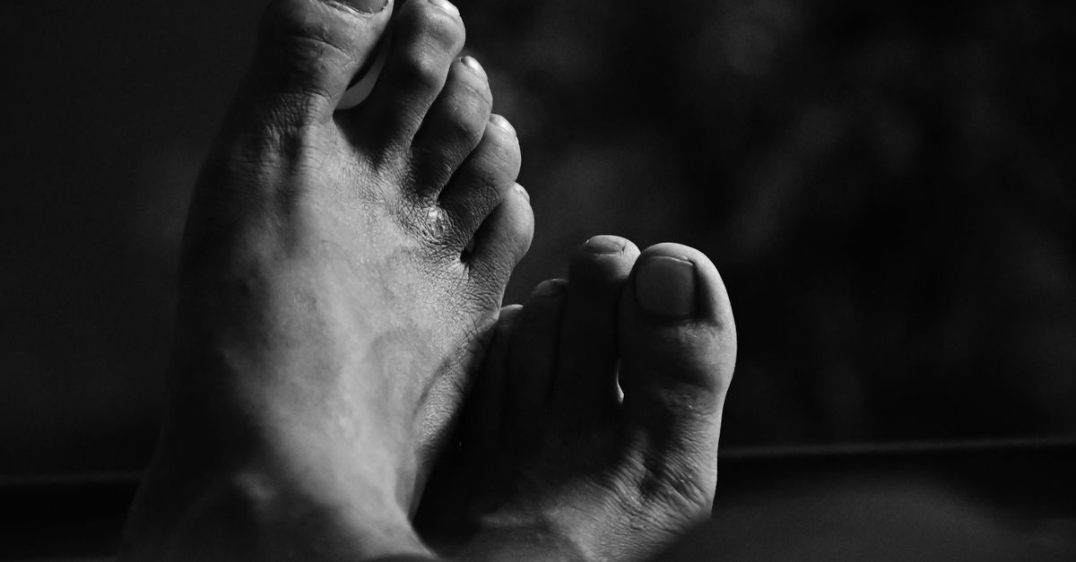 Monochrome close-up of bare feet in a relaxed pose. Artistic and calming.
