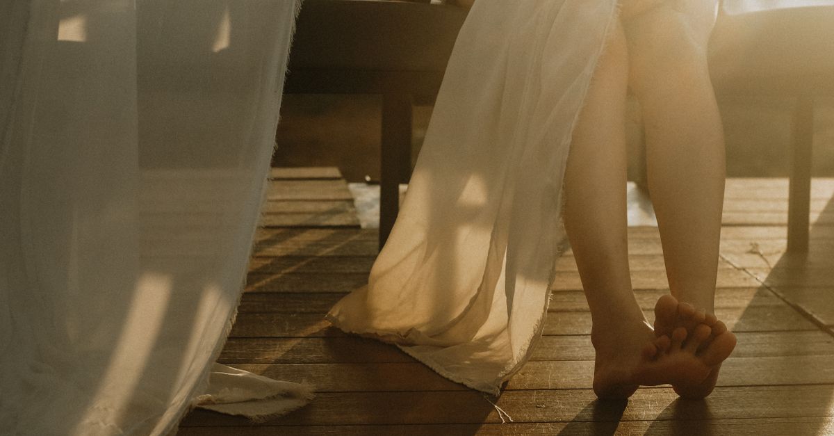 A peaceful indoor scene with sunlight casting soft shadows on wooden floors and linen.