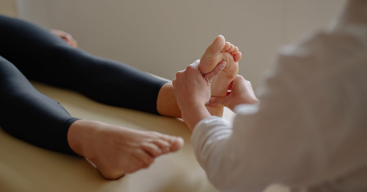 Close-up of a foot massage therapy session with a therapist working on a client's foot.