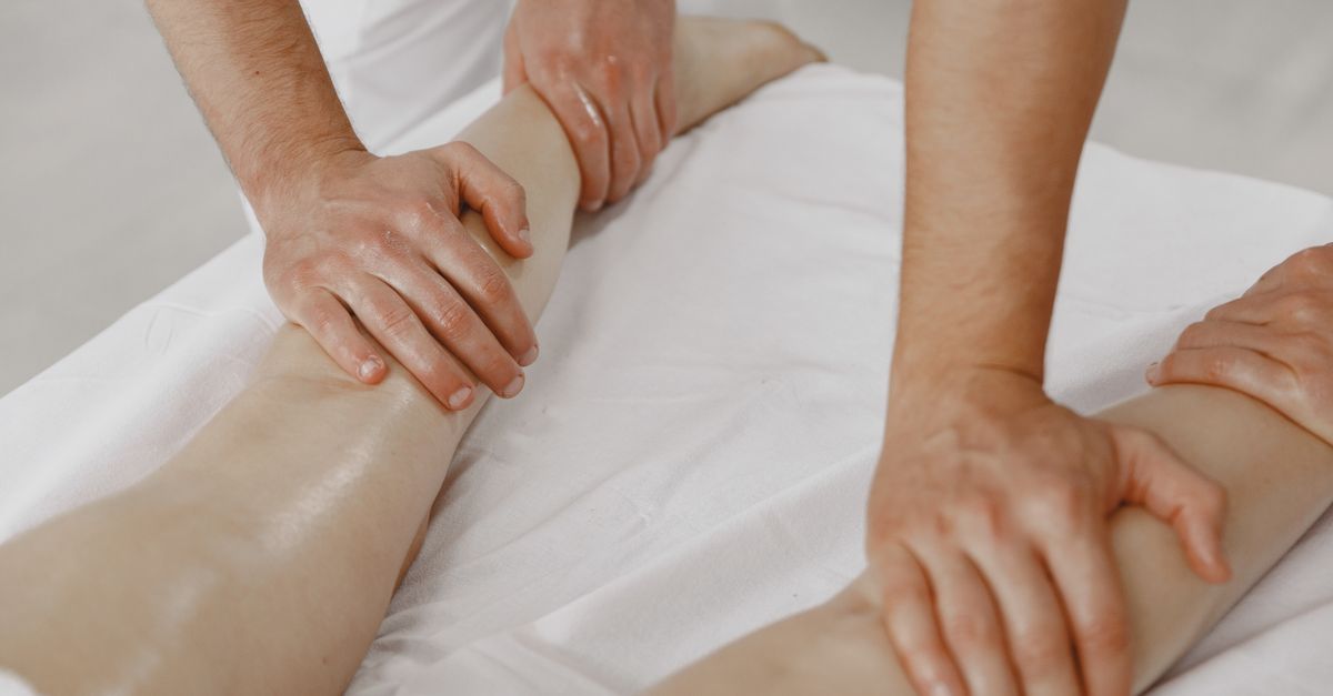 A close-up view of a leg massage in a relaxing spa environment.