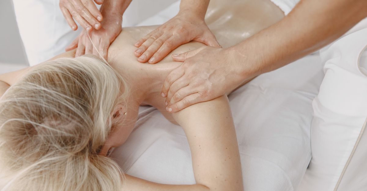 Woman receiving a relaxing back massage promoting wellness and stress relief.
