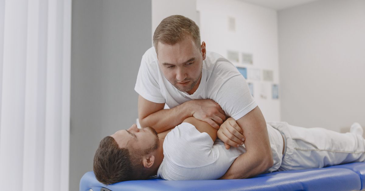 A massage therapist performing a body massage for relaxation in a professional setting.