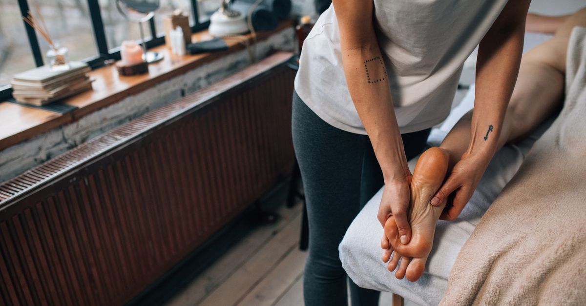 Professional foot massage in a serene and cozy indoor setting.