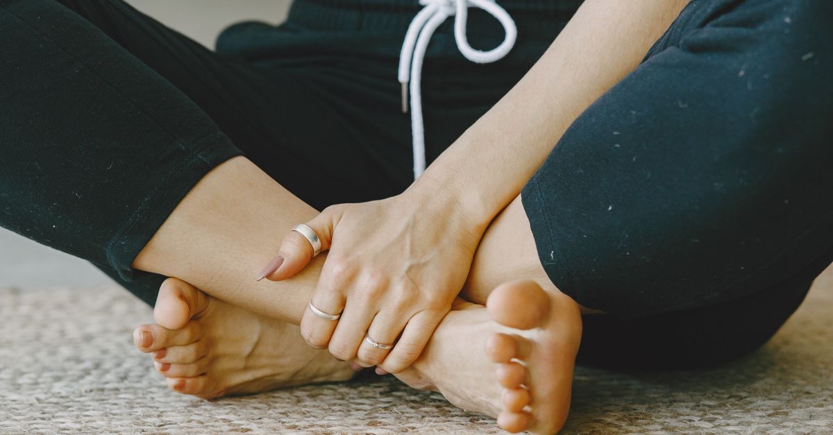 A calming close-up of crossed bare feet on a carpet, conveying relaxation and mindfulness.