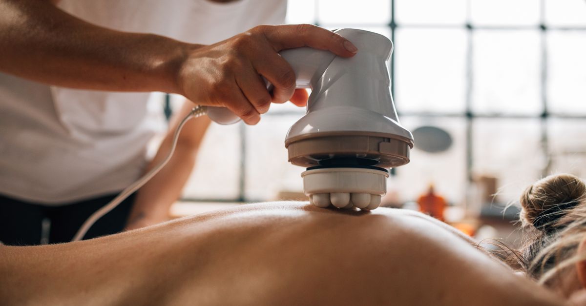 A body massage session using an electronic massager, promoting relaxation.